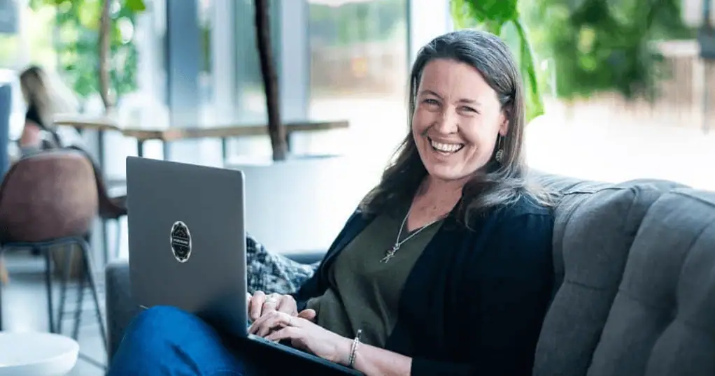 Death Doula Websites Sarah Juliasson working on laptop