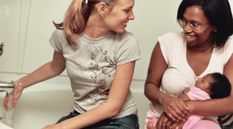 doula with mom and baby, drawing up a bath