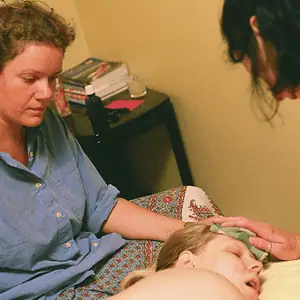 doula and midwife supporting mom in labor