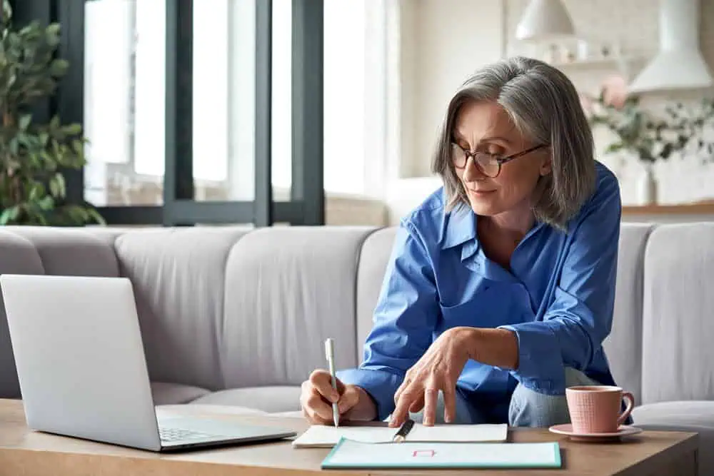 woman working on computer on couch